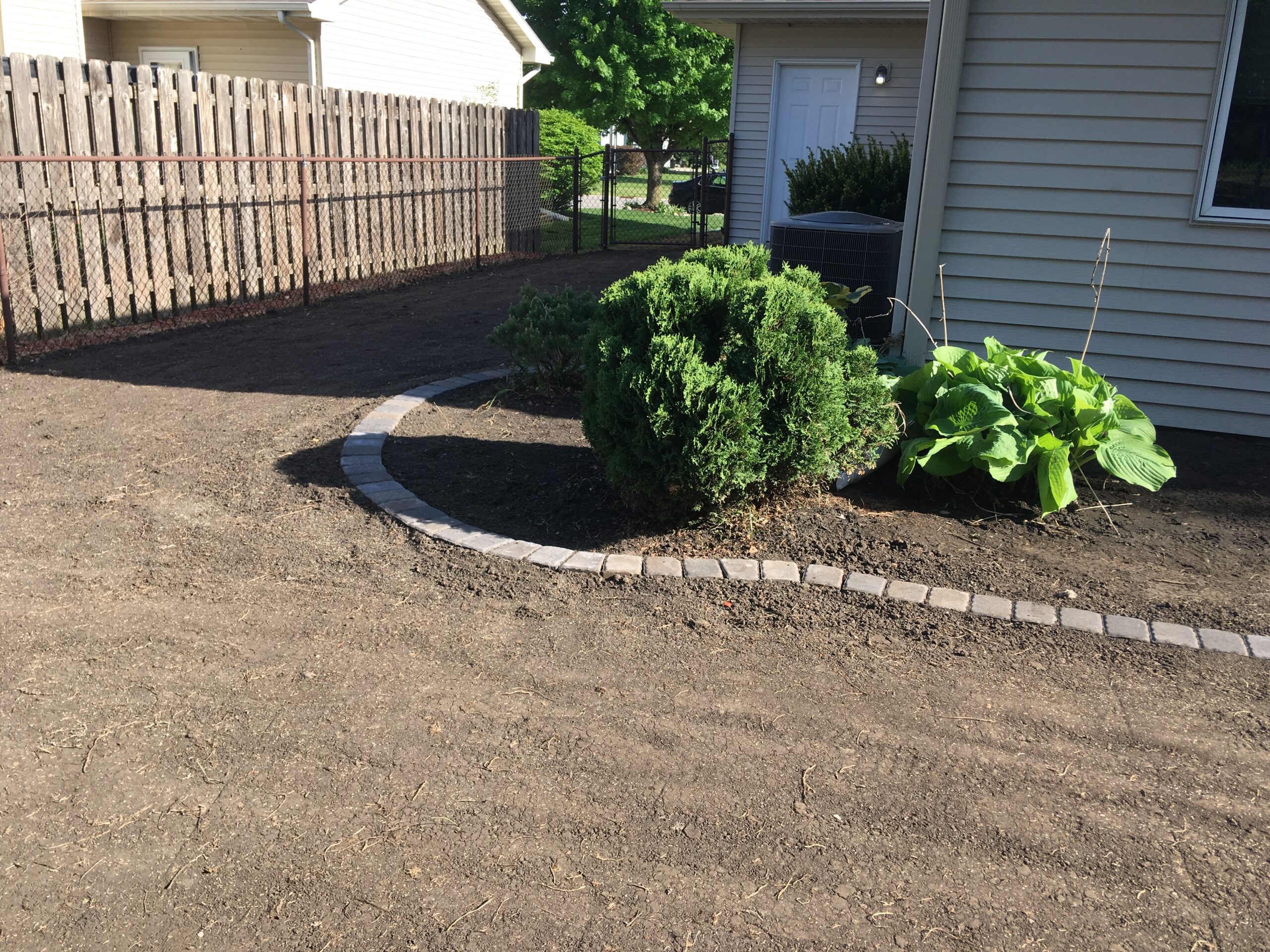 Raised against foundation, new soil fir lawn